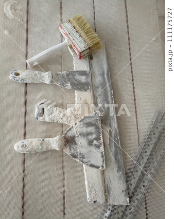 spatula for painters on a wooden chair spatula for painters on a wooden chair 111175727