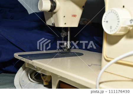 Sewing machine, needle and needle holder close-up. 111176430