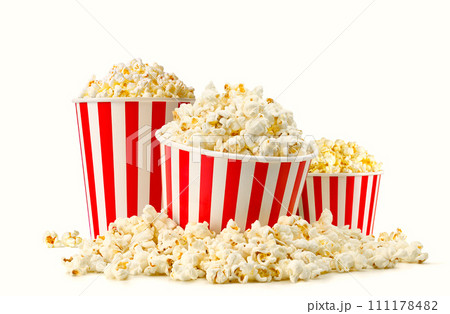 Popcorn buckets in a big pile of popcorn isolated on white background Popcorn buckets in a big pile of popcorn isolated on white background 111178482