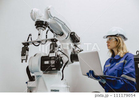Engineer women university student learn control operate and program industry robot arm with laptop computer in robotics engineers lab classroom in polytechnic education. Engineer women university student learn control operate and program industry robot arm with laptop computer in robotics engineers lab classroom in polytechnic education. 111179054
