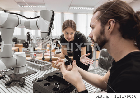 Industrial Robotics program university students learning education mechanical assembly with Robot Universal Training Platform robot arm simulation model in engineering lab classroom. Industrial Robotics program university students learning education mechanical assembly with Robot Universal Training Platform robot arm simulation model in engineering lab classroom. 111179056