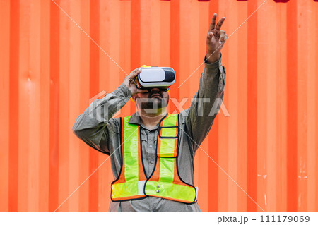 Worker Using VR Vision Pro Technology Equipment Headset Device Work at Container Yard Construction site Innovation in Logistics Industry Worker Using VR Vision Pro Technology Equipment Headset Device Work at Container Yard Construction site Innovation in Logistics Industry 111179069