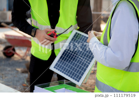 Team young engineer or architect meeting and planning installation solar panel at construction site. Team young engineer or architect meeting and planning installation solar panel at construction site. 111179519