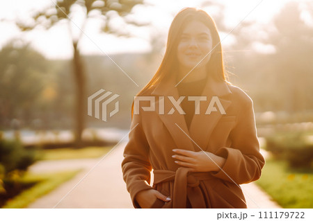 Pretty woman with smartphone having a good time in autumn weekend. People, lifestyle concept. 111179722