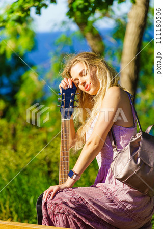 Girl with guitar outdoor on nature Girl with guitar outdoor on nature 111180506
