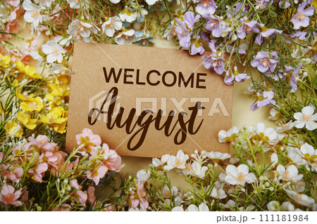 Welcome August text message with flower decoration on yellow background 111181984