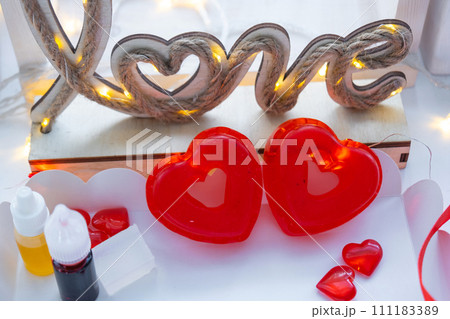 Handmade homemade soap in the shape of hearts for a Valentine's Day gift to your beloved. Perfumes and dyes, soap base on the table Handmade homemade soap in the shape of hearts for a Valentine's Day gift to your beloved. Perfumes and dyes, soap base on the table 111183389