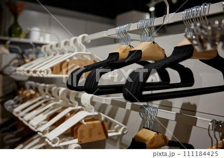 Many hangers for clothes on shop store rack 111184425