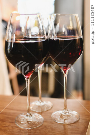 The glasses with red French wine in a restaurant The glasses with red French wine in a restaurant 111185487