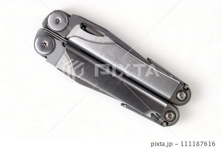 Folded steel multitool isolated on white background, top view. A tool for daily practice. All in one. Construction and repair. Compact and portable product. Pocket knife. EDC concept 111187616