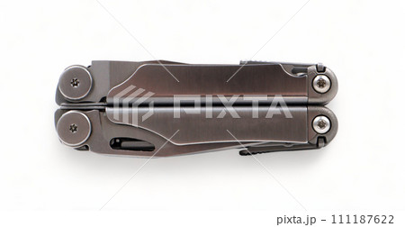 Folded steel multitool isolated on white background, top view. A tool for daily practice. All in one. Construction and repair. Compact and portable product. Pocket knife. EDC concept Folded steel multitool isolated on white background, top view. A tool for daily practice. All in one. Construction and repair. Compact and portable product. Pocket knife. EDC concept 111187622
