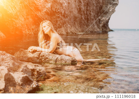 Woman travel sea. Happy tourist enjoy taking picture outdoors for memories. Woman traveler swim in the sea bay with mountains, sharing travel adventure journey 111196018
