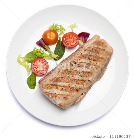 grilled cooked piece of tuna fillet on ceramic plate isolated on white background grilled cooked piece of tuna fillet on ceramic plate isolated on white background 111196337