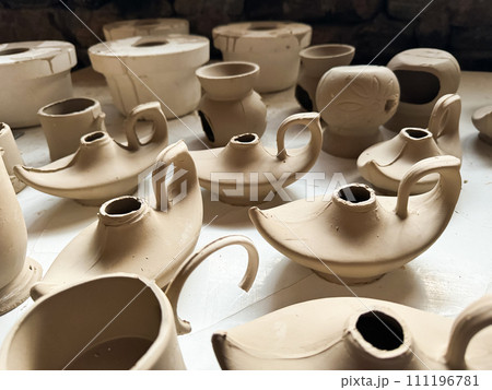 Clay blanks for a kerosene lamp in a pottery workshop. Close up photo Clay blanks for a kerosene lamp in a pottery workshop. Close up photo 111196781