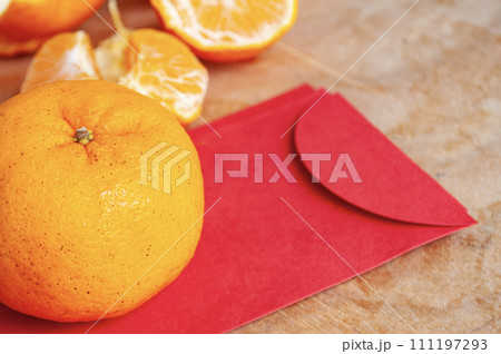 Mandarin orange on top of Chinese New Year red packet. Chinese New Year celebration concept 111197293