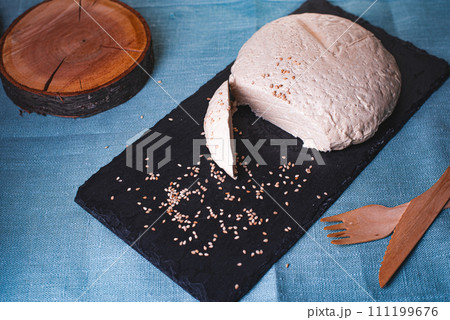 Sesame halva on stone black board with blue background. 111199676