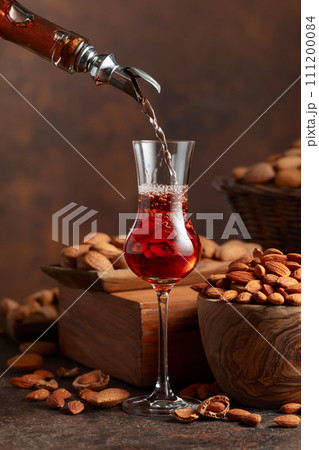 Italian liqueur Amaretto with almonds nuts. Italian liqueur Amaretto with almonds nuts. 111200084