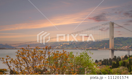 Bosphorus Bridge: a majestic marvel connecting Europe and Asia, shimmering under Istanbul's setting sun Bosphorus Bridge: a majestic marvel connecting Europe and Asia, shimmering under Istanbul's setting sun 111201574