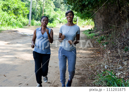 Two women doing sport together in the park Two women doing sport together in the park 111201875