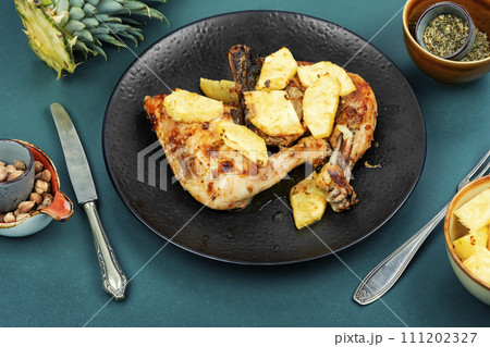 Barbecued chicken drumsticks and pineapple. Barbecued chicken drumsticks and pineapple. 111202327