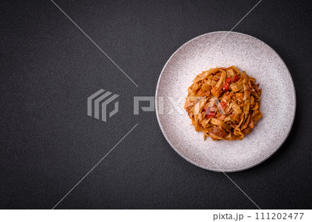 Delicious asian udon dish with vegetables, mushrooms, salt and spices 111202477