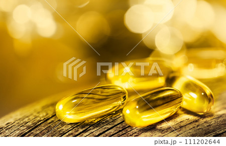 Fish Oil Pills on wooden and shiny background. 111202644