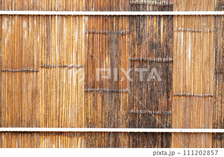 Wheathered bamboo wall built on white frame 111202857