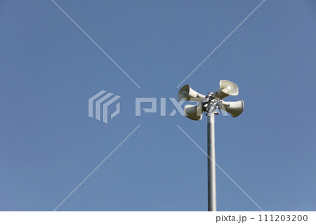 Whire horn speaker in the park with clear blue sky background.. Whire horn speaker in the park with clear blue sky background.. 111203200