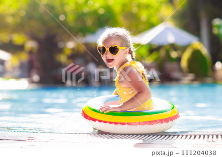 Child in swimming pool. Kids swim. Water play. 111204038