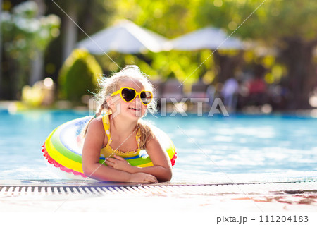 Child in swimming pool. Kids swim. Water play. 111204183