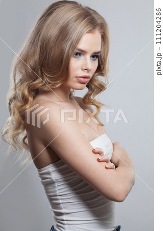 Charming healthy blonde model posing isolated on white background. Woman with make-up Charming healthy blonde model posing isolated on white background. Woman with make-up 111204286