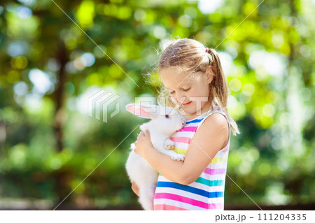 Child with rabbit. Easter bunny. Kids and pets. Child with rabbit. Easter bunny. Kids and pets. 111204335