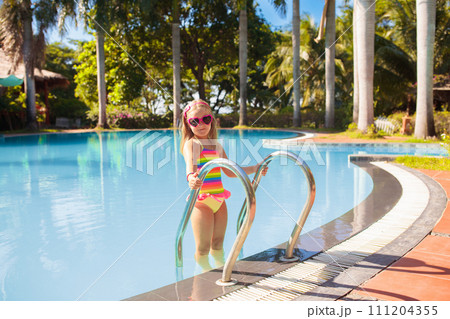 Child in swimming pool with ball. Kids swim. Child in swimming pool with ball. Kids swim. 111204355