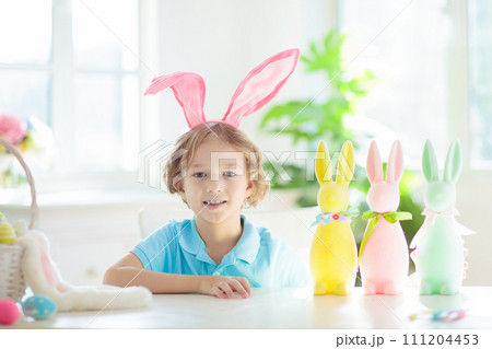 Kids on Easter egg hunt. Children dye eggs. Kids on Easter egg hunt. Children dye eggs. 111204453