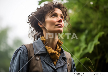 Portrait of a beautiful girl in a denim jacket and scarf in nature. 111209396