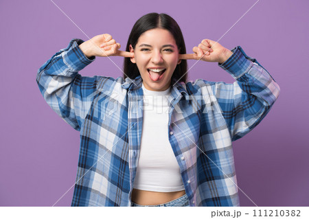 I don't want to hear. Childish behaviour from a young woman 29s, sticking fingers in ears and showing her tongue I don't want to hear. Childish behaviour from a young woman 29s, sticking fingers in ears and showing her tongue 111210382