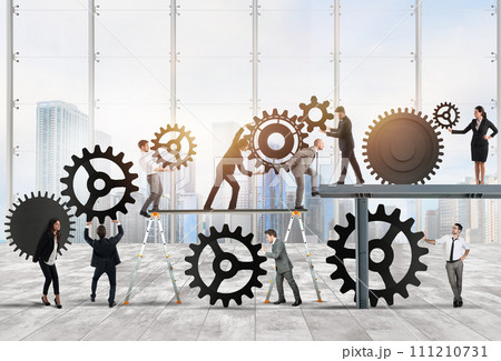 Teamwork of businesspeople work together to a system of gears as integration concept 111210731