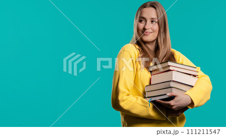 Happy student woman with stack books from library, blue background. Copy space Happy student woman with stack books from library, blue background. Copy space 111211547