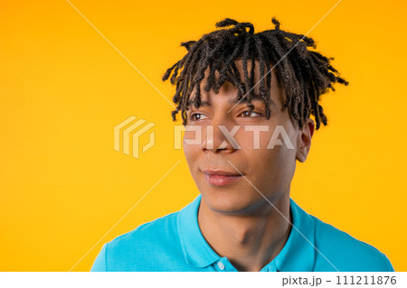 Friendly young man on yellow studio background. Copy space. Teenager student guy Friendly young man on yellow studio background. Copy space. Teenager student guy 111211876