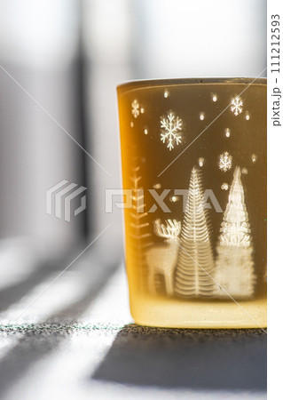 Christmas candle glass in sunny day 111212593