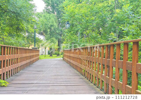 Old wooden bridge in town, natural vintage background Old wooden bridge in town, natural vintage background 111212728