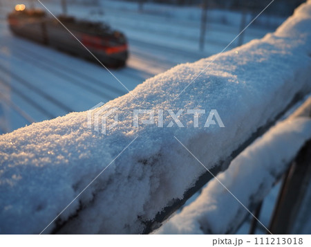 Snow, crust and frozen crust on metal railings. Suspension bridge over railway tracks. Harsh arctic climate. Abnormally low air temperatures. Frosty morning. Weather forecast. High snow cover. Snow, crust and frozen crust on metal railings. Suspension bridge over railway tracks. Harsh arctic climate. Abnormally low air temperatures. Frosty morning. Weather forecast. High snow cover. 111213018