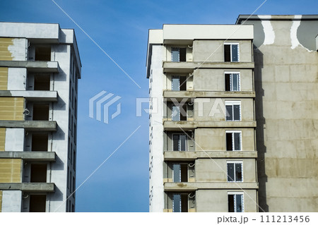 Unfinished new high rise buildings. Building against the blue sky. Unfinished new high rise buildings. Building against the blue sky. 111213456