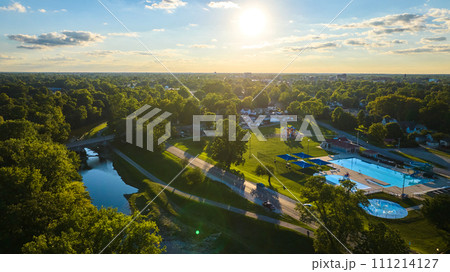 Tuhey Pool aerial in late afternoon with golden sunshine over neighborhood and White River, Muncie 111214127