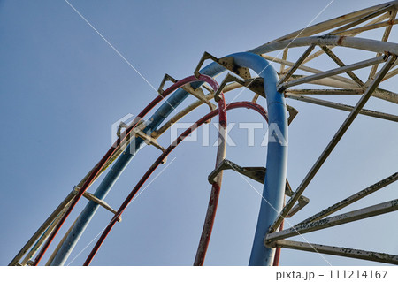 Red and Blue Roller Coaster Tracks Against Blue Sky, Upward View 111214167