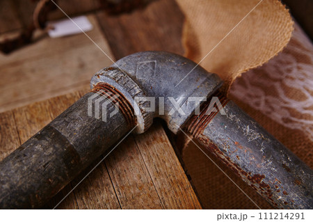 Vintage Pipe Corner on Wooden Surface with Rustic Backdrop 111214291