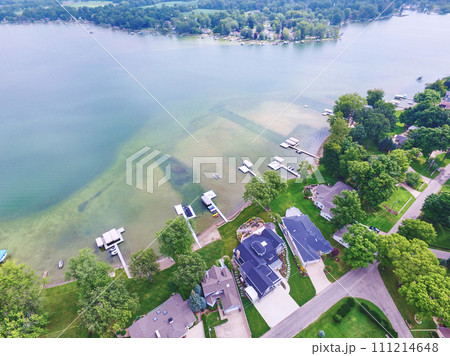 Aerial View of Serene Lakeside Community with Docks and Boats 111214648