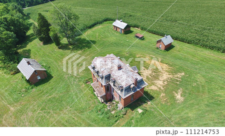 Aerial View of Abandoned Rural Mansion with Lush Surroundings Aerial View of Abandoned Rural Mansion with Lush Surroundings 111214753