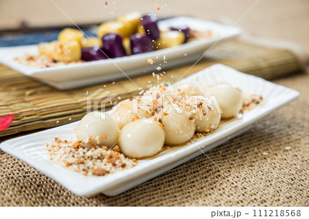 Taiwanese traditional sweet and dessert, glutinous rice dumplings and sweet potato dumplings with coconut sugar and peanuts and coconut flakes 111218568