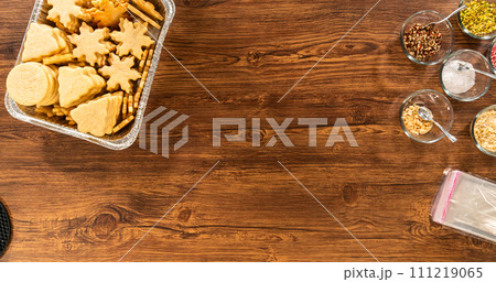 Golden-hued cookies shaped like snowflakes, intricately stacked. Golden-hued cookies shaped like snowflakes, intricately stacked. 111219065